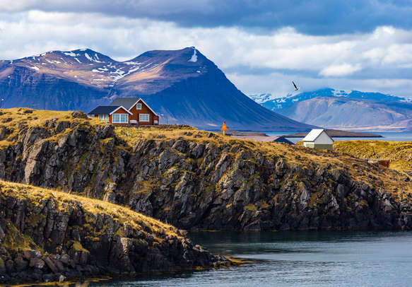 Typical Icelandic landscape with houses against mountains in small village of Stykkisholmur