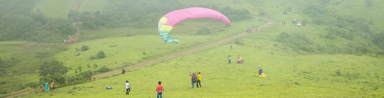 Experience the thrill of flying during this paragliding in Vagamon