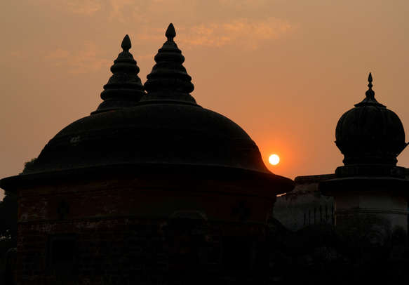 Old temple domes in silhouettte against Sunset background in Ayodhya