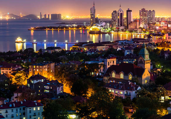 Qingdao Bay and the Lutheran church seen from the hill of Signal Park at night