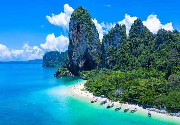 Aerial view of amazing Phra Nang Cave Beach with traditional long tail boat