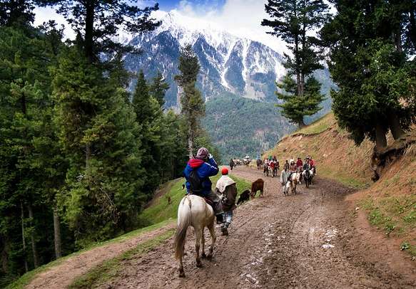 Tourists enjoy horse riding to Pahalgam valley