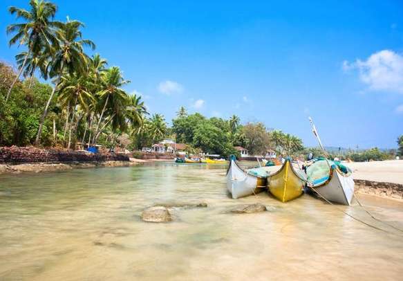 Relax on the Baga beach on your Goa holiday.