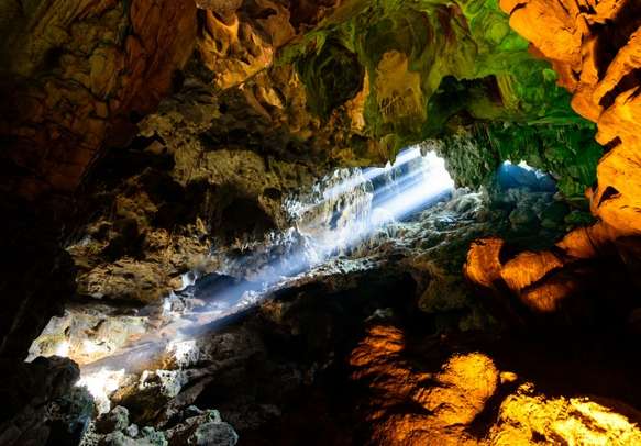 Walk through the rugged and exciting Surprise Cave in Halong Bay