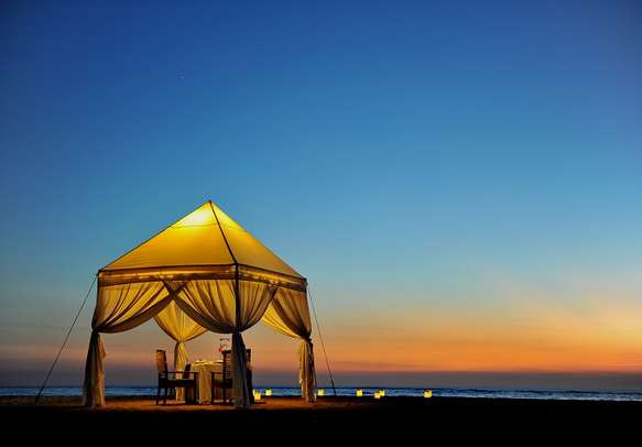 Romantic dinner setting for two on a beach in Bali.