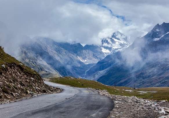Delight in a scenic drive on Manali Highway Road with mountains on one side