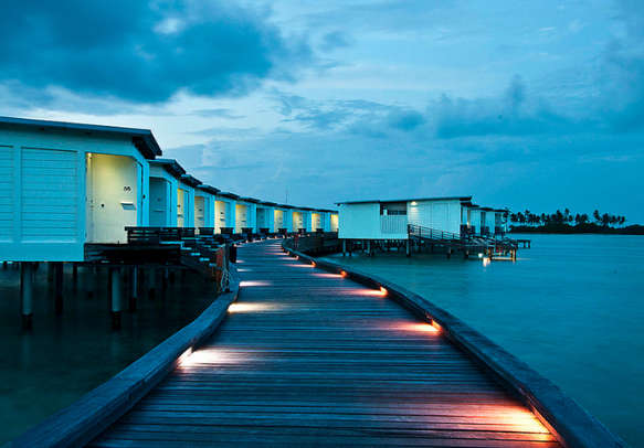 The evening views of dimly lit Maldives resorts are bewitching