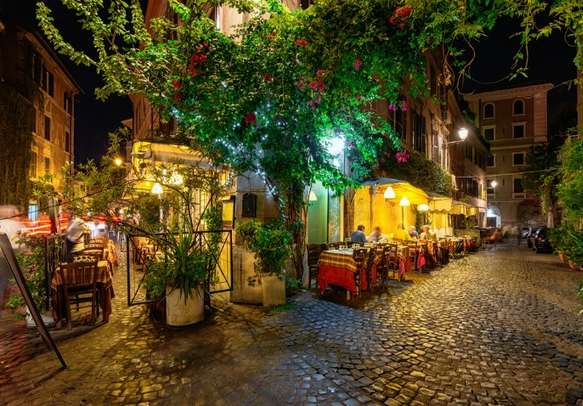 Traverse through this old cozy street at night in Rome