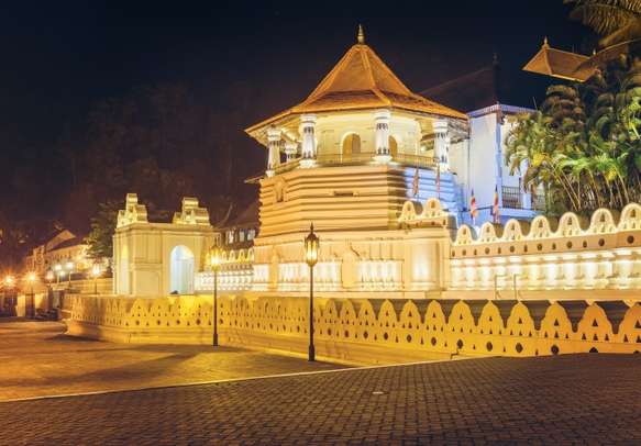 Night view of the Temple of the Buddha Tooth with lights. Kandy