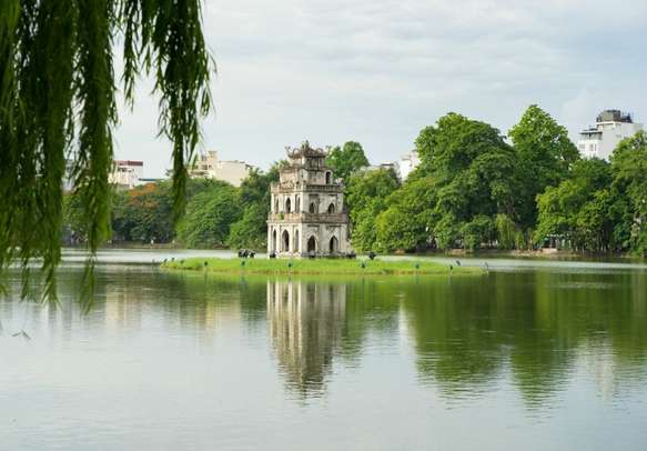 Hoan Kiem lake (Sword lake, Ho Guom) in Hanoi, Vietnam with willow branches on foreground