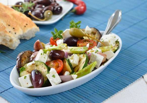 Savor Greek fried vegetables with feta cheese, olives, and pita bread