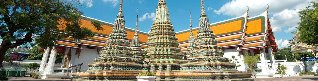 Great Palace Buddhist temple with famous green tree gardens in center of Bangkok