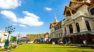 Great Palace Buddhist temple with famous green tree gardens in center of Bangkok