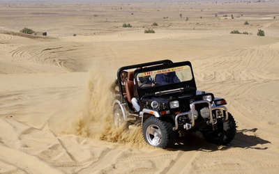Tourists taking a jeep safari in Jaisalmer