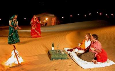 Tourists watching the Rajasthani folk dance in a camp at night