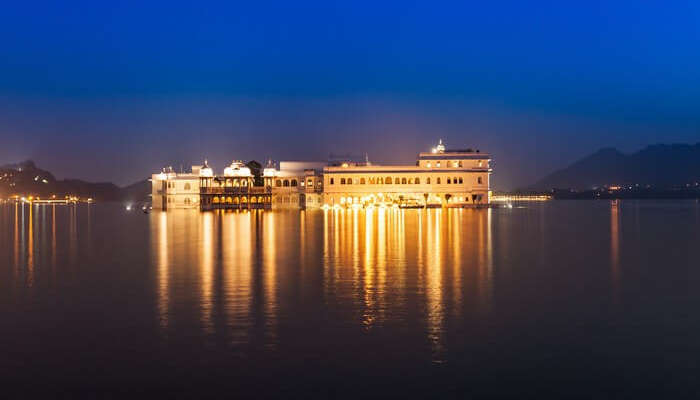 An illuminated Lake Palace is a popular tourist attraction in Rajasthan