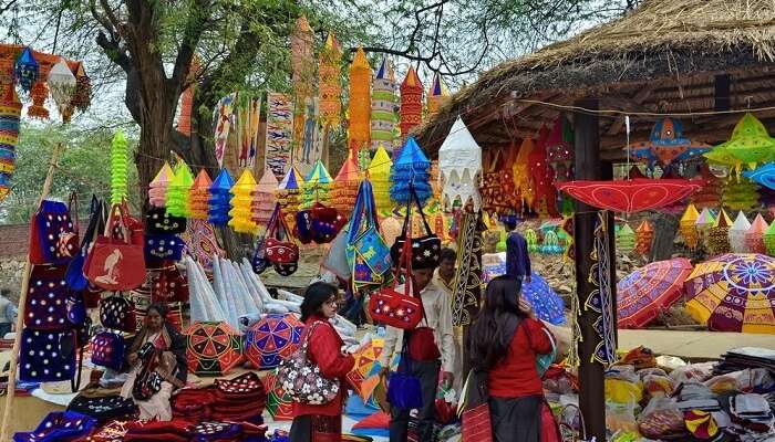 Tourists buying colorful products at the Surajkund Mela in Faridabad