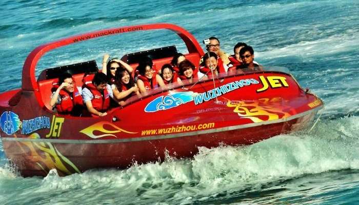 Tourists ride speed boat near Wuzhizhou Island in Sanya, China