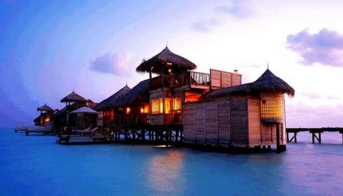 A beautiful view of a water villa during the evening hours in Bali