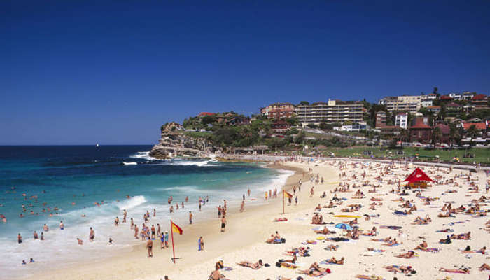 Tourists relax and enjoy at the Bondi beach