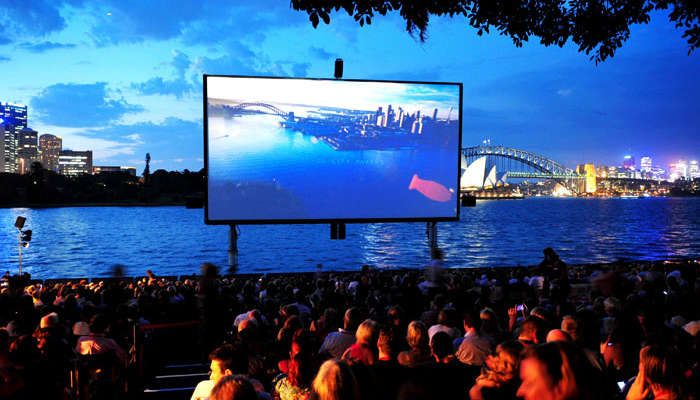 At St George Oper Air Cinema you can watch the screen rise, breaking the water surface, with the Opera House the Harbor Bridge, and the setting sun in the backdrop