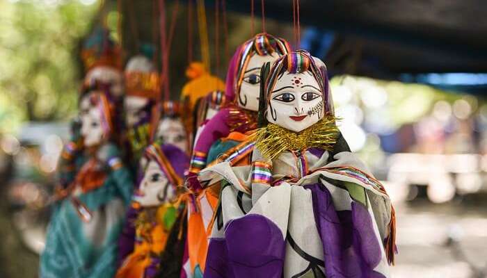 Rajasthani puppet dolls hanging from a cord at Chetak Circle in Udaipur