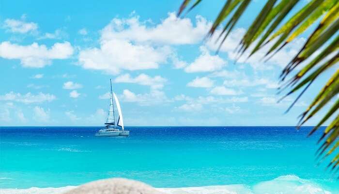 A shot from the Anse Georgette beach on Praslin island of a yacht in the blue waters