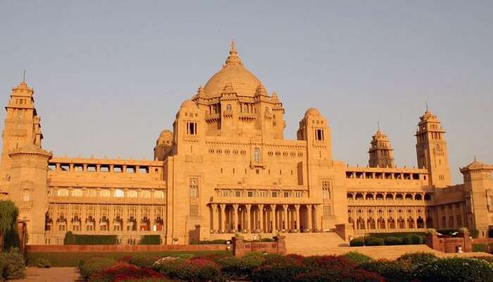 The beautiful garden and the yellow sandstone monument of the Taj Umaid Bhawan Palace