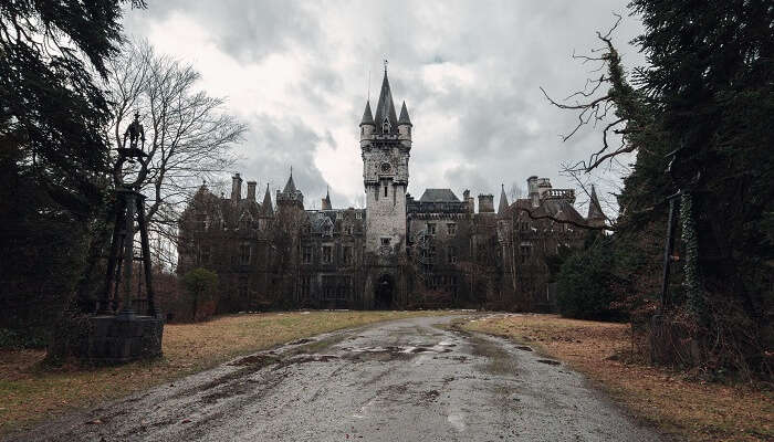 The abandoned and creepy Miranda Castle on a dark and gray day in fall