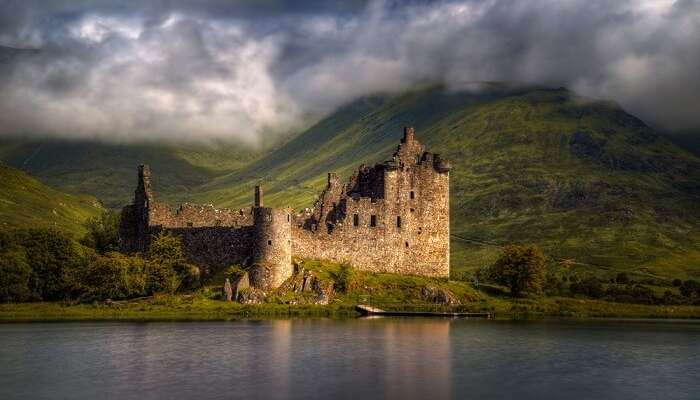 Reflections of the Kilchurn Castle in morning light in Scotland