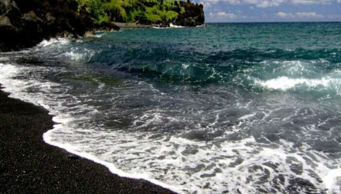 A 2021 Compilation Of 59 Weirdest Places Across the World You Should Stop By 36 Have a view of the black sand amidst the crystal clear waters