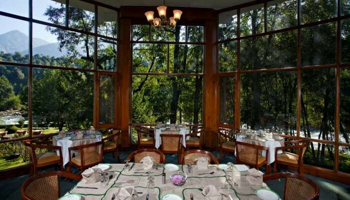 Restaurant at Span Resort & Spa with the backdrop of mountains and river