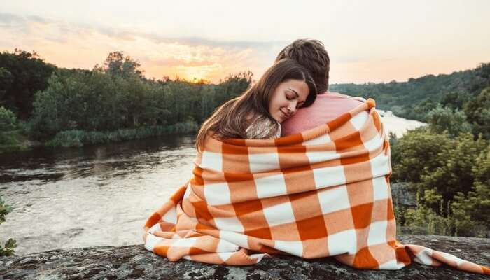 A couple enjoying the sunset on their honeymoon