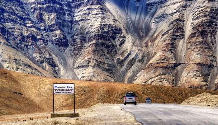 A 2021 Compilation Of 59 Weirdest Places Across the World You Should Stop By 53 A vehicle moving on the road that leads to Magnetic Hill