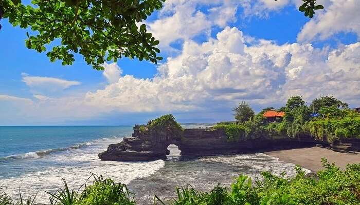 Bow down at Tanah Lot temple in Bali, Indonesia