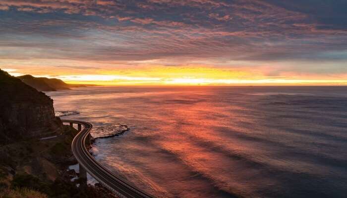 Romantic drive by the ocean at sunset in Australia