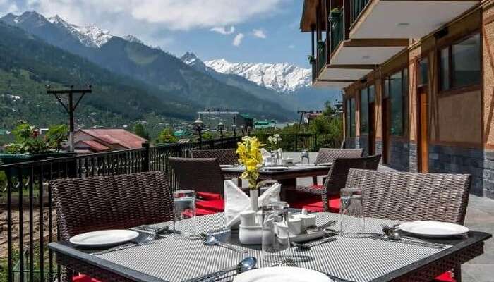 Open roof dining of Anantmaya in Manali overlooking mountains