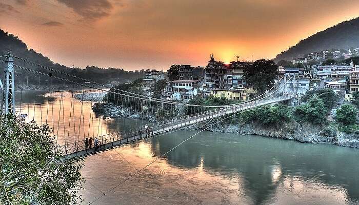 A sunset view of the Laxman Jhula and the city of Rishikesh