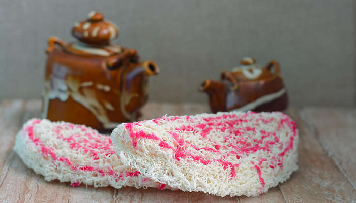 Asmi sweet garnished with pink syrup