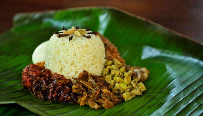 rice and meat on a banana leaf