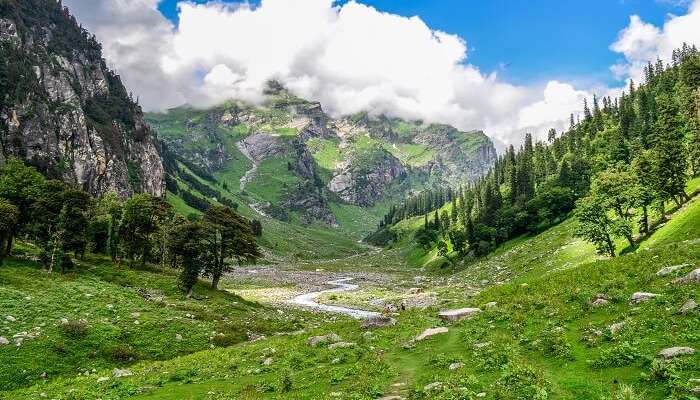 A lush green mountain pass enroute Hampta Pass Trek in Himachal