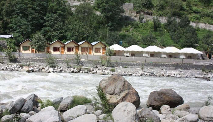 Tents of Kia Camps by the river in Manali
