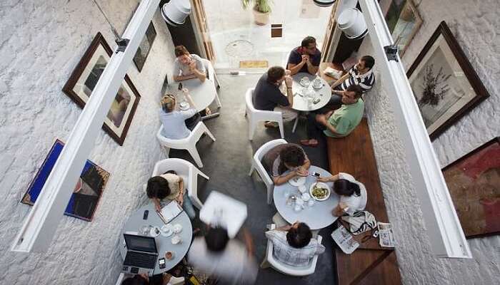Top view of people sitting together having food at Kala Ghoda Cafe in Mumbai 