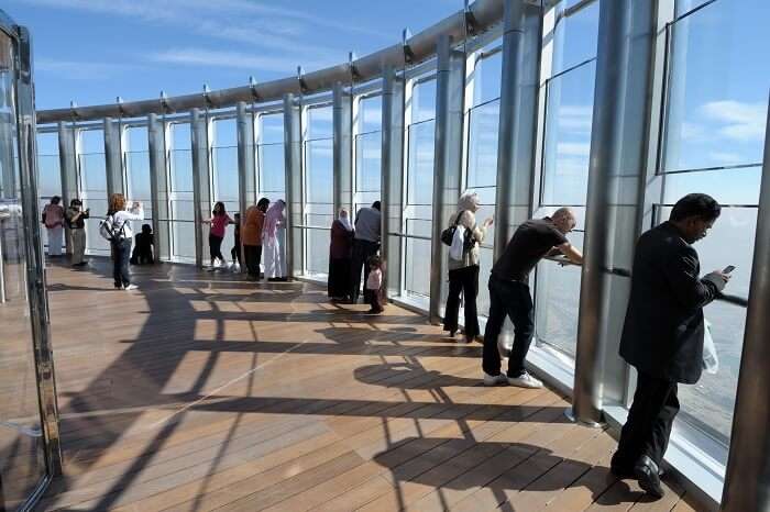 Tourists looking out from the observation deck at Burj Khalifa