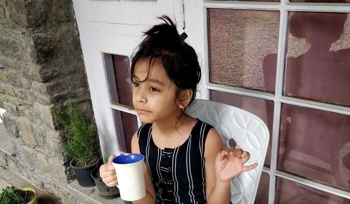 little traveler sipping up tea in nainital's ashdale resort