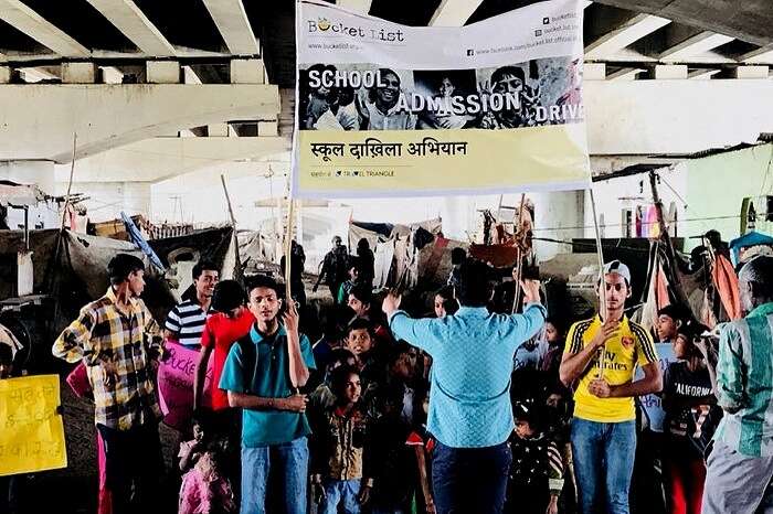 Organisers and students gather for a rally during the school admission drive