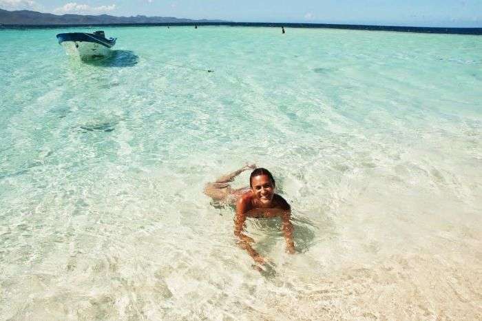 A girl swimming in the deep Green Waters at Cayo Arena