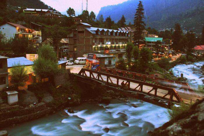 A scenic view of the flowing beas and the bridge leading to Old Manali