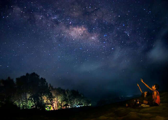 Two children enjoy the breathtaking experience of stargazing at Tarkarli