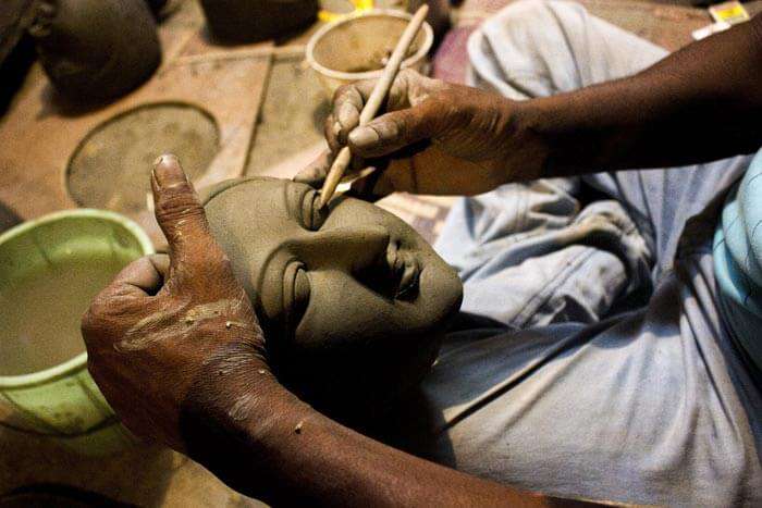 An artist making idol of Durga Maa for Durga Puja 2015
